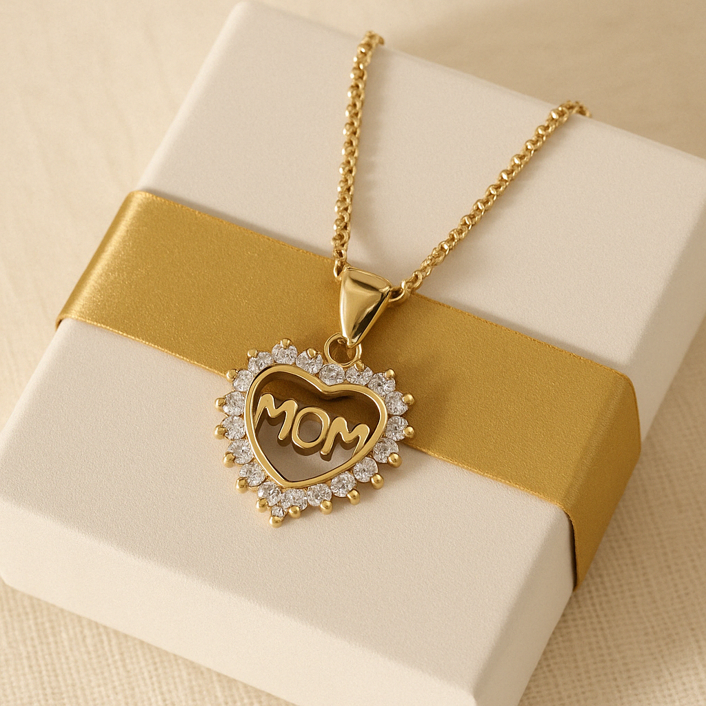 Gold-plated MOM heart pendant necklace on soft satin fabric